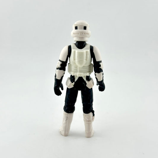 Toy figure in a white and black costume on a light gray background