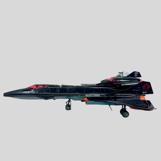 Model of a black fighter jet on a white background