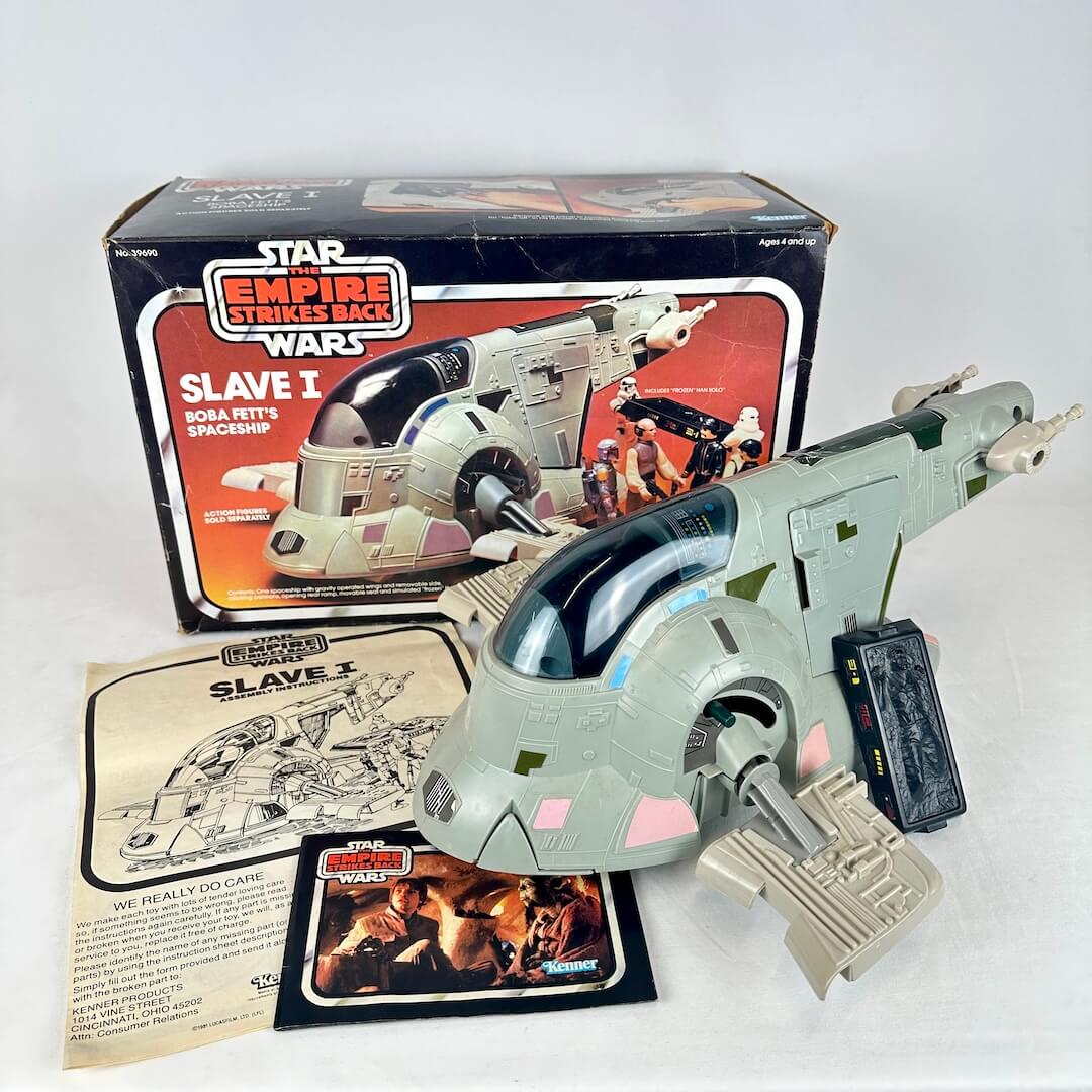 Vintage Star Wars Slave I toy with packaging and accessories on a white background