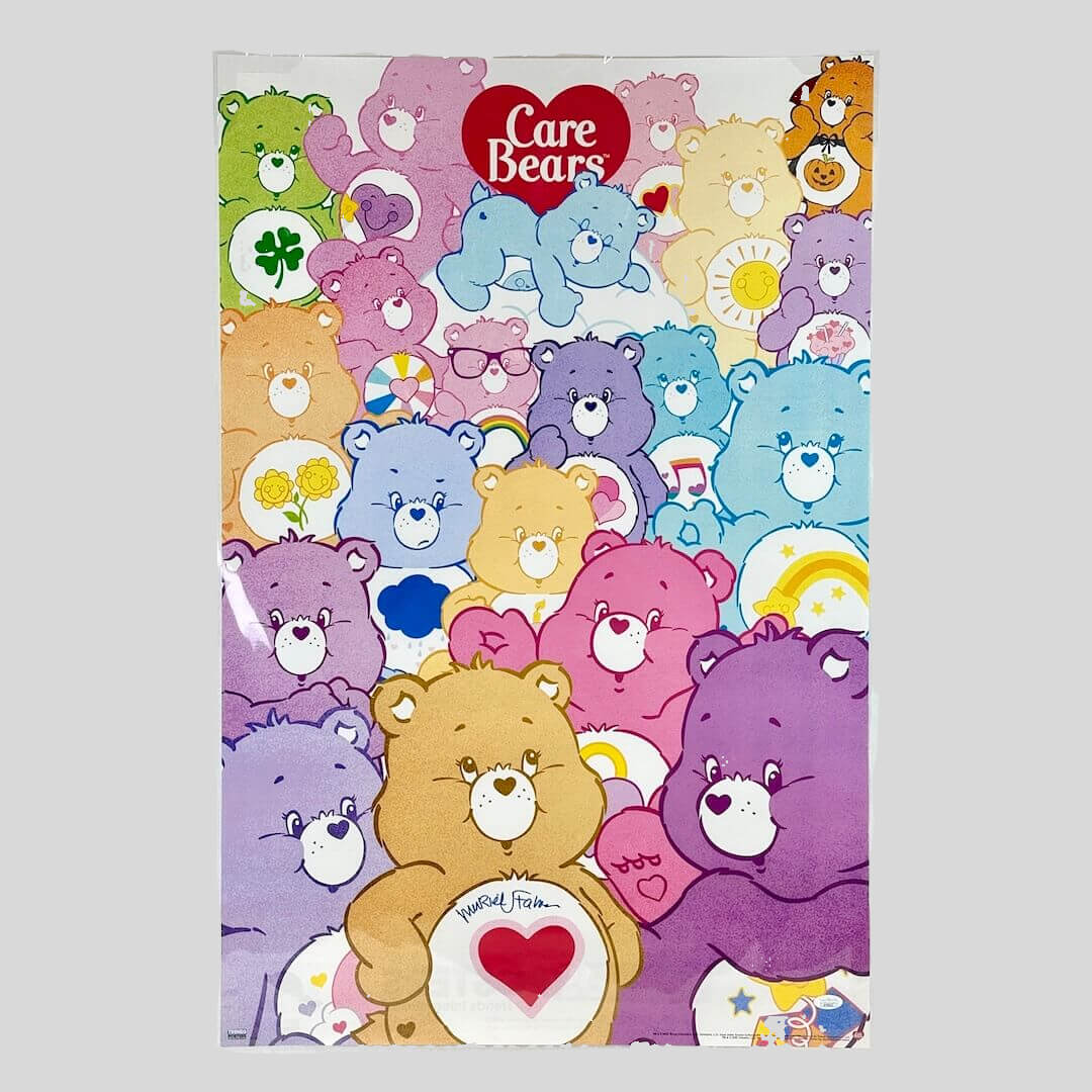 Care Bears poster with multiple bears and the Care Bears logo. Signature in black marker towards bottom.