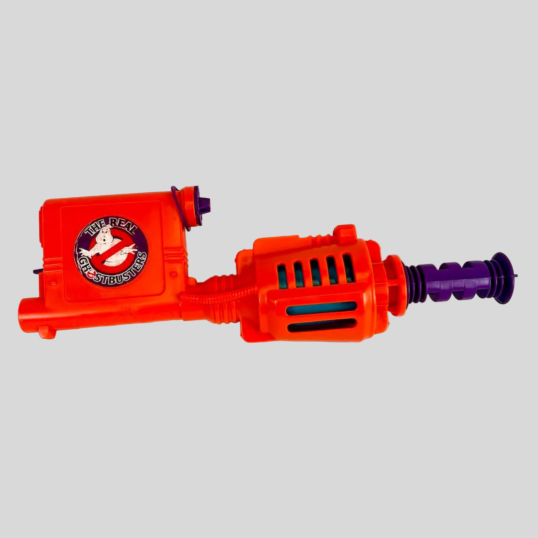 Orange toy gun with purple accents on a white background