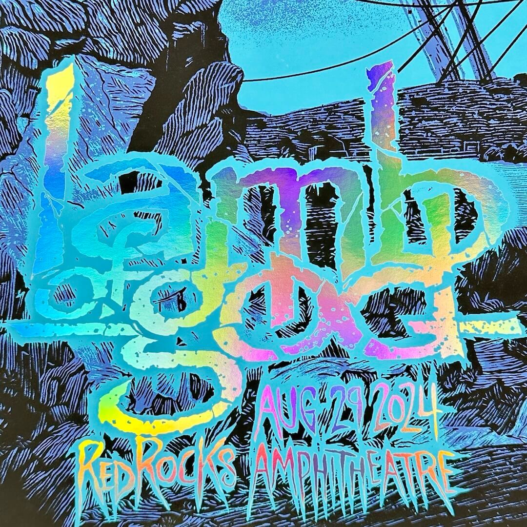 Close up of rainbow foil effect in artist name and event info. Line graphics of rocks from venue visible.