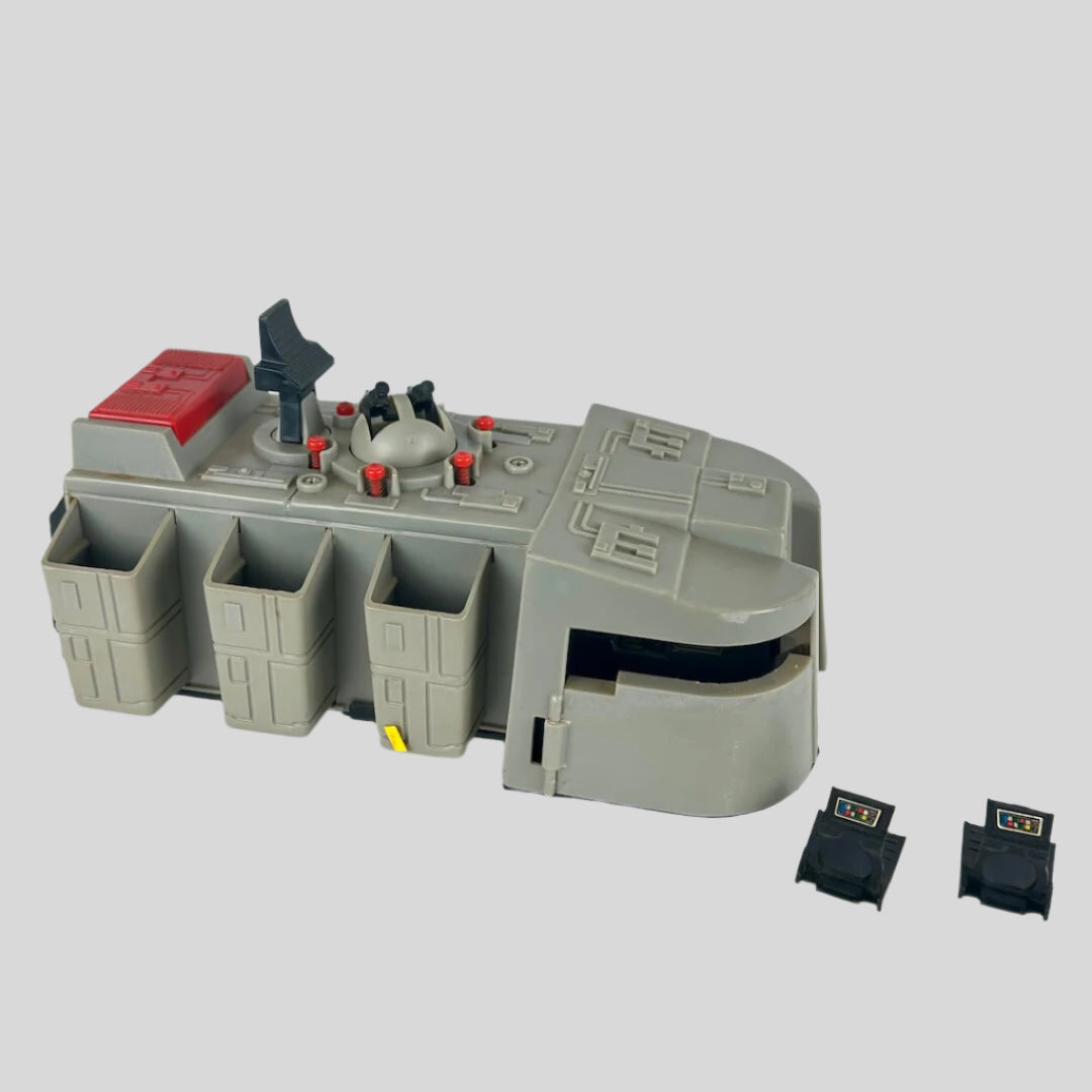 Toy space vehicle with several compartments and two separate black pieces.