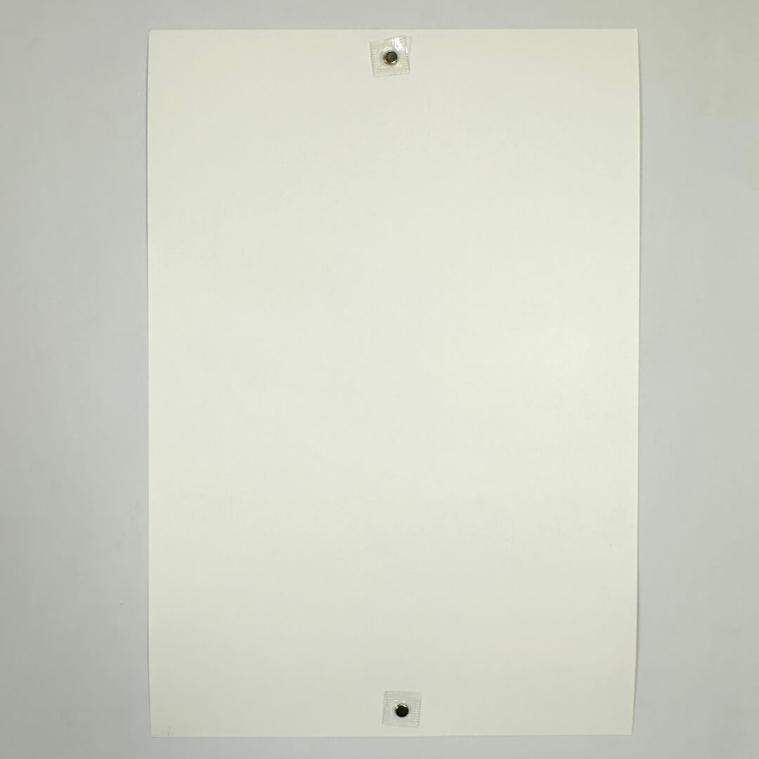 Backside of white poster to show pristine condition against white background.