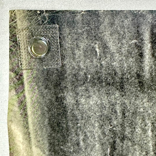 Top left corner of poster with creases at corner and some scratches.