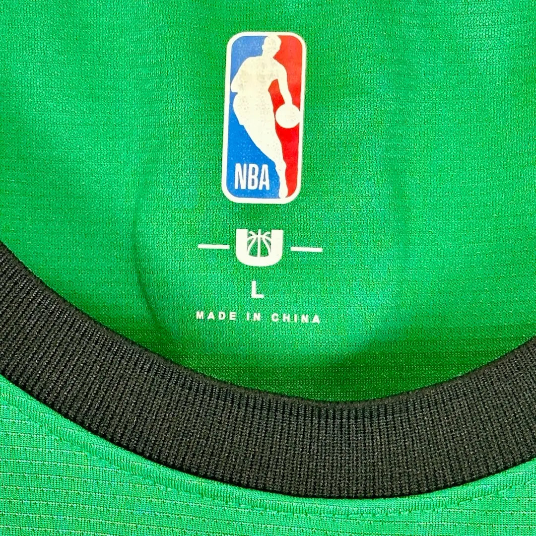 Close up of interior neck tag, NBA logo printed on jersey with "L, Made in China" beneath it.
