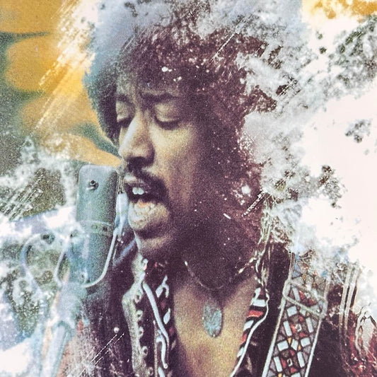 Close-up of Hendrix' face singing into a microphone with smokey accents.