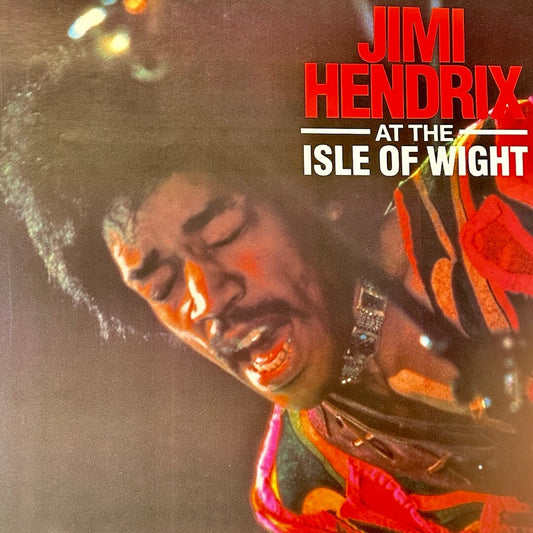 Close-up on Jimi Hendrix singing with red and white text to right.