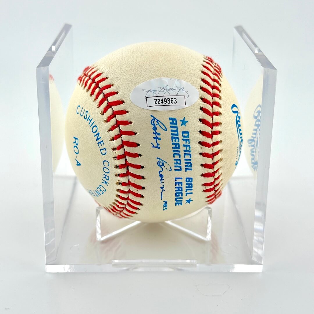 Signed baseball in clear display cube with Rawlings branding and JSA sticker.