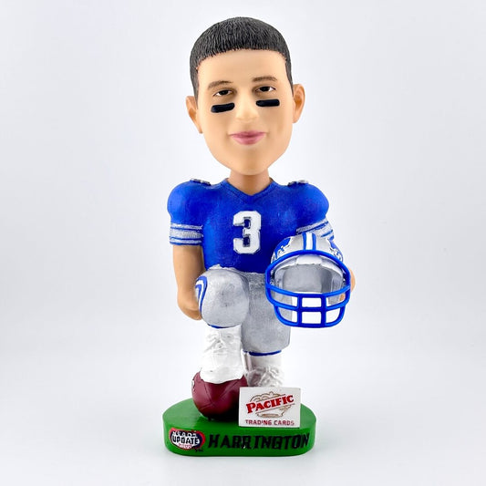 Bobblehead of football player in blue jersey holding a helmet against white background.