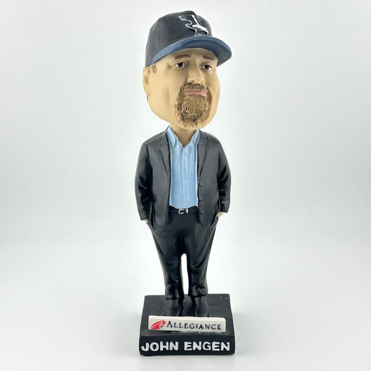 Bobblehead figure of a man in a suit with a cap, standing on an 'Allegiance' base, against a white background.