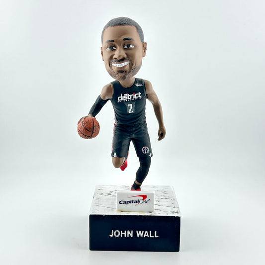 Bobblehead figure of a basketball player holding a ball on a white background