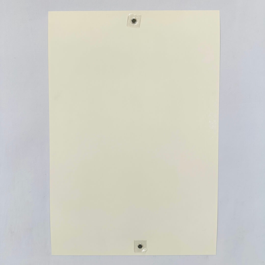 Backside of cream colored poster showing pristine condition against white background.