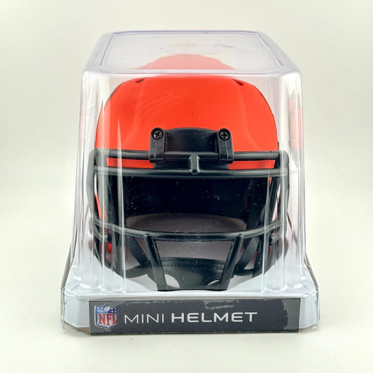 Orange mini football helmet in clear packaging with NFL logo on a white background