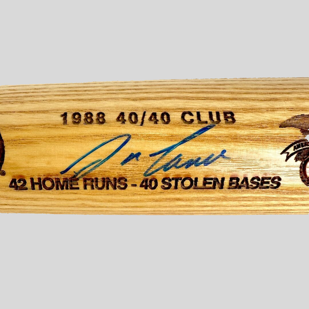 Baseball bat with text embossed and blue marker signature.