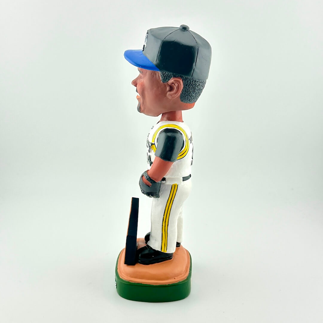 Bobblehead figure of a baseball player in uniform with a bat on a white background