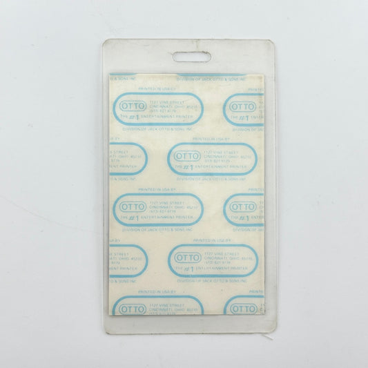 backside of badge to show intact paper backing and mint condition inside lamination.