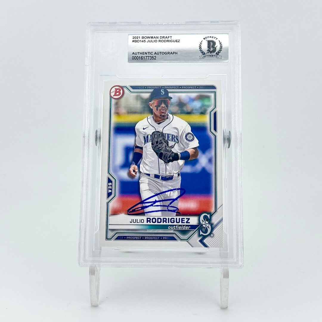 Baseball trading card of a player in a white uniform with a blue cap, encased in a clear holder on a light gray background.