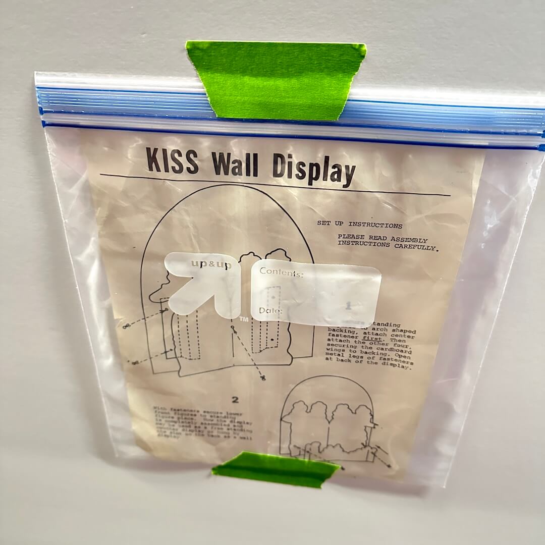 Clear plastic bag with printed instructions and diagrams, taped shut on a white background