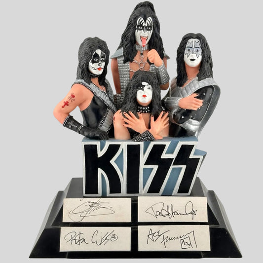 Black pedestal with icons of all members of KISS in full dress coming from top of KISS logo.