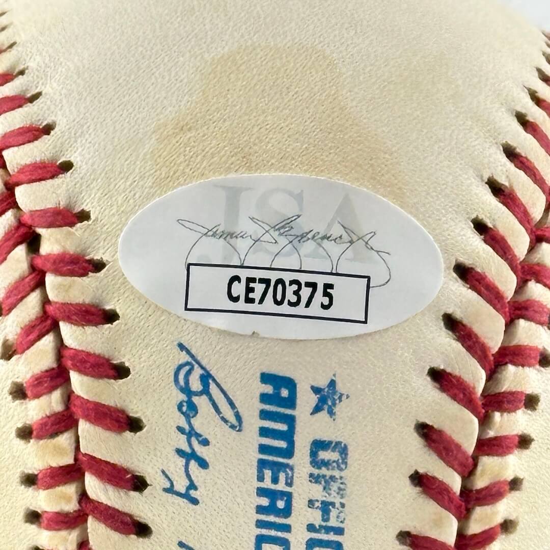 Close up of JSA authentication sticker next to MLB ball information stamp.