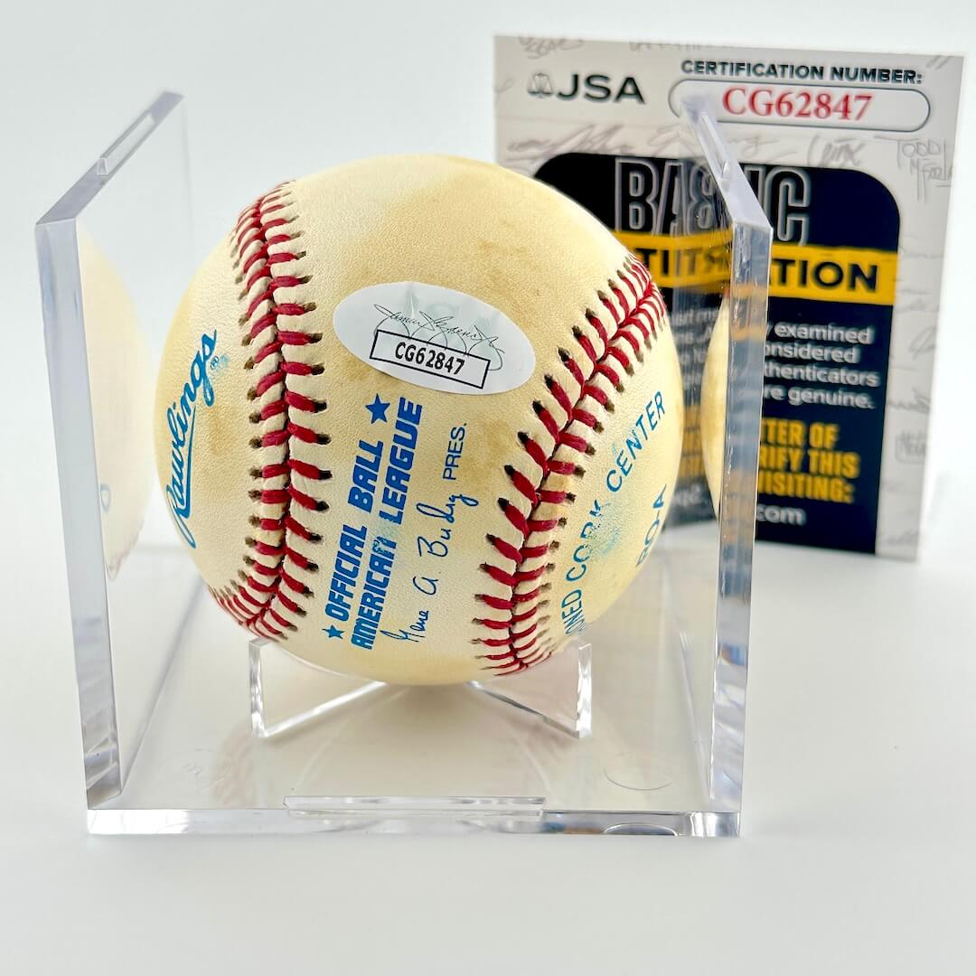 Signed baseball in clear display cube with JSA sticker and certificate card.