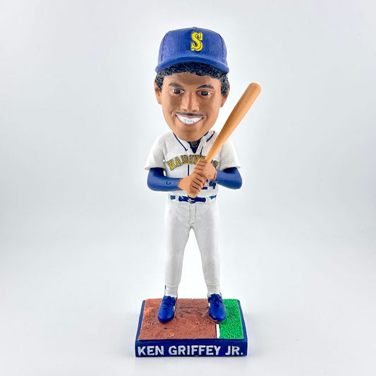 Bobblehead of a baseball player in a Mariners uniform holding a bat on a white background
