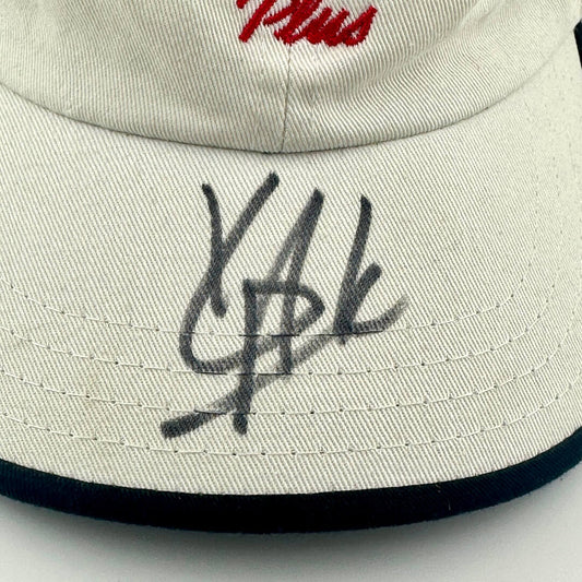 hat with black signature and red text on a white background