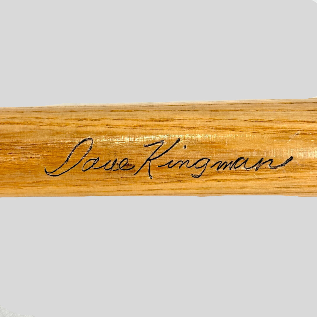 Wooden bat with engraved name 'Dave Kingman' on a white background