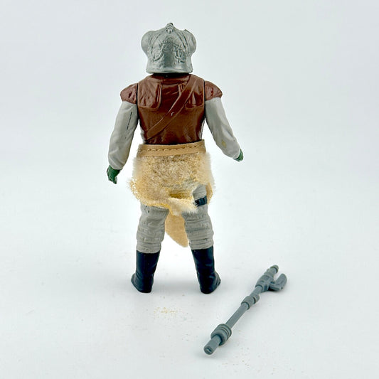 Alien action figure with accessory on white background.