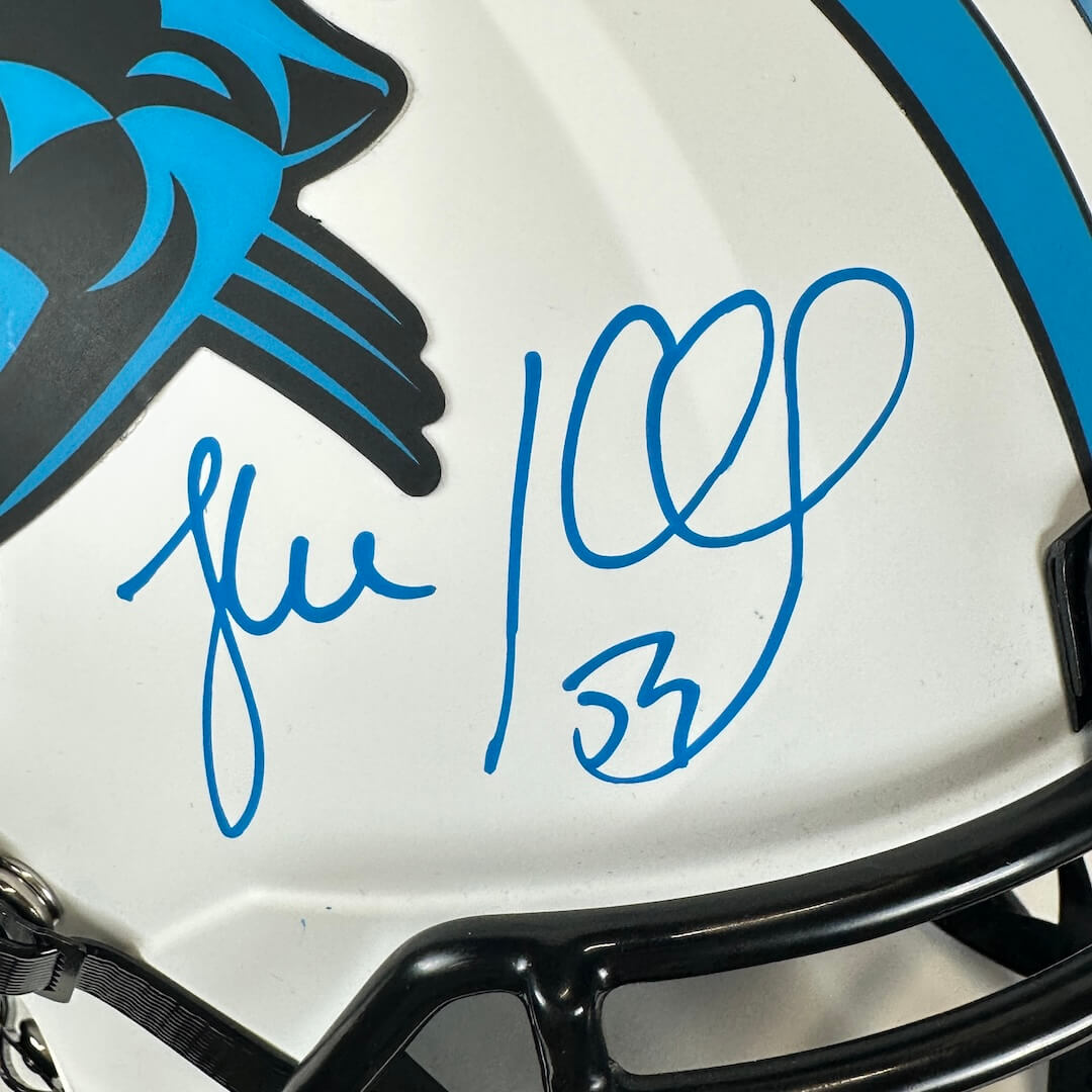 Close up of blue marker signature in white space in front of panther logo.