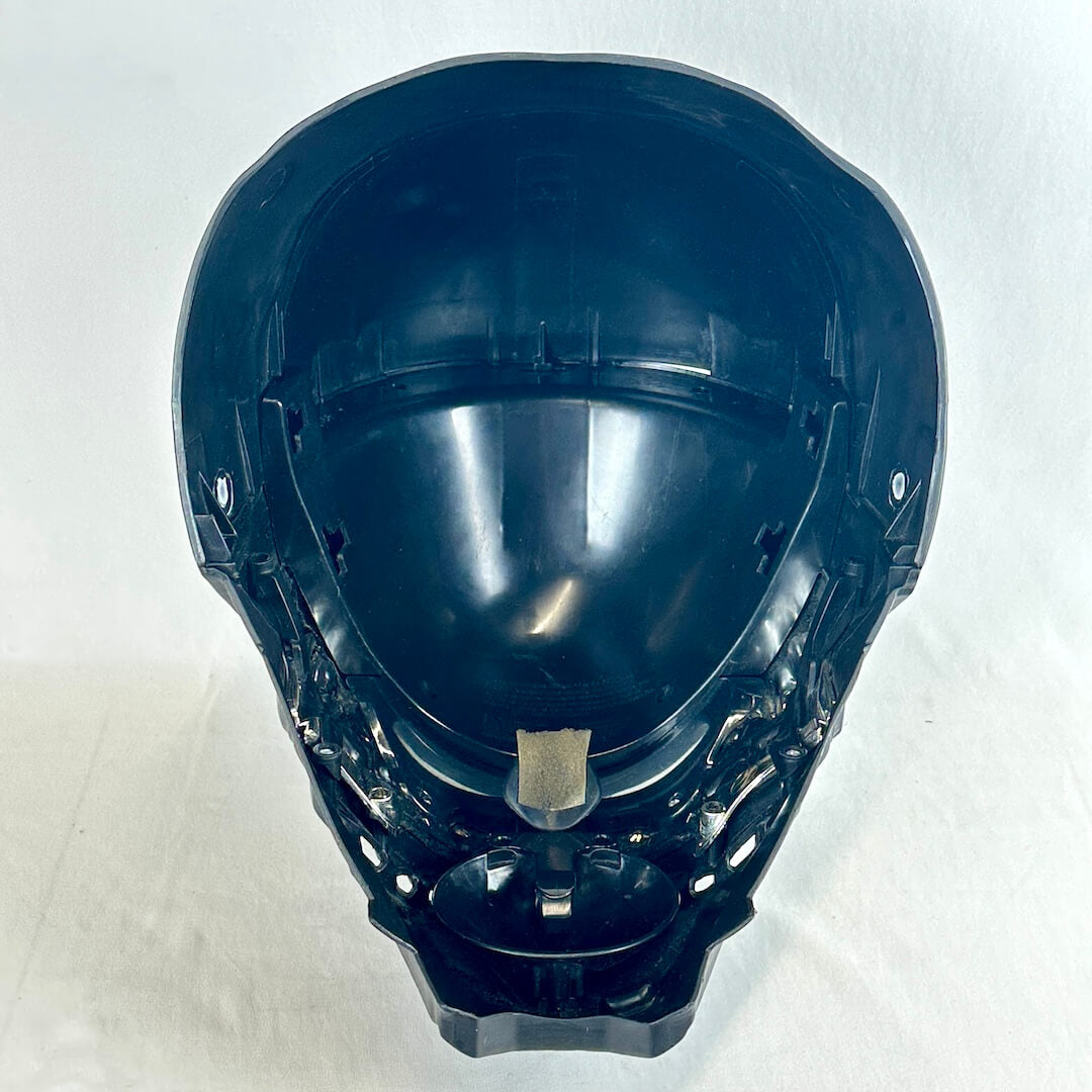 A black plastic full-face helmet shell, photographed from above against a plain off-white background.