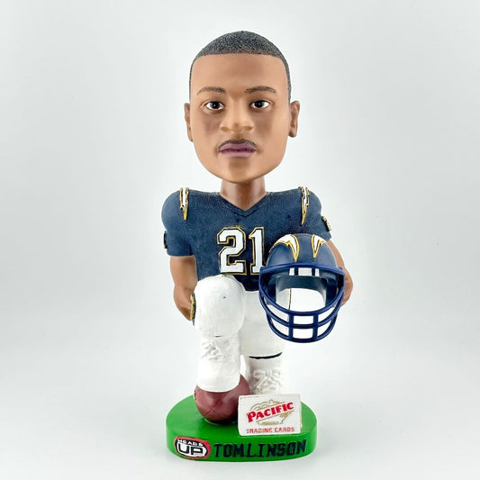 Bobblehead of a football player holding a helmet on a white background