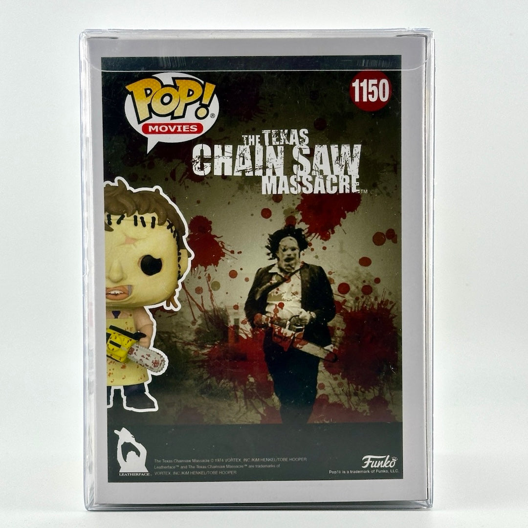 Chainsaw wielding vinyl figure still in box with red marker signature of Mark Burnham, Leatherface, across plastic window.