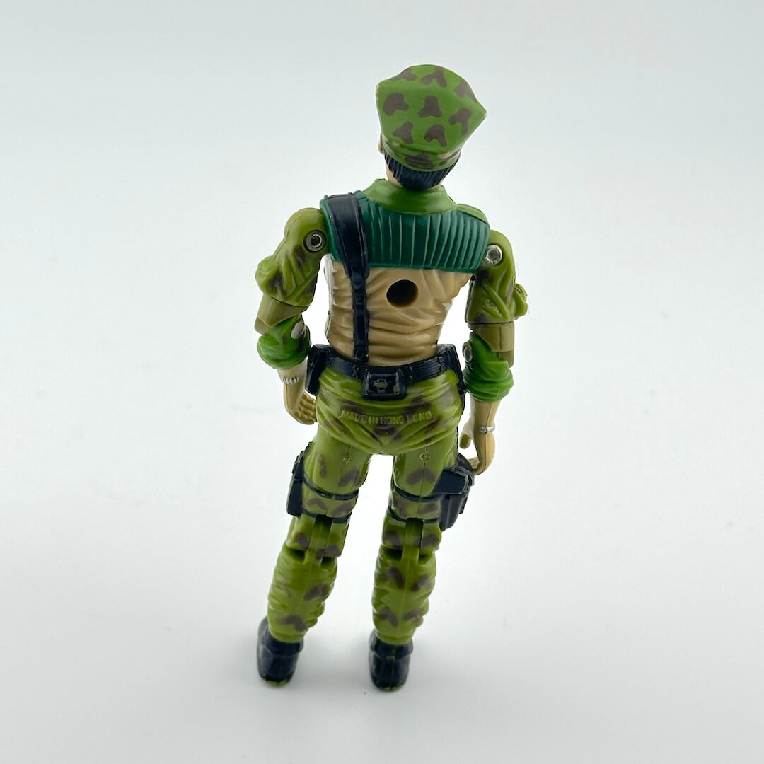 Green action figure with camouflage pattern on a white background