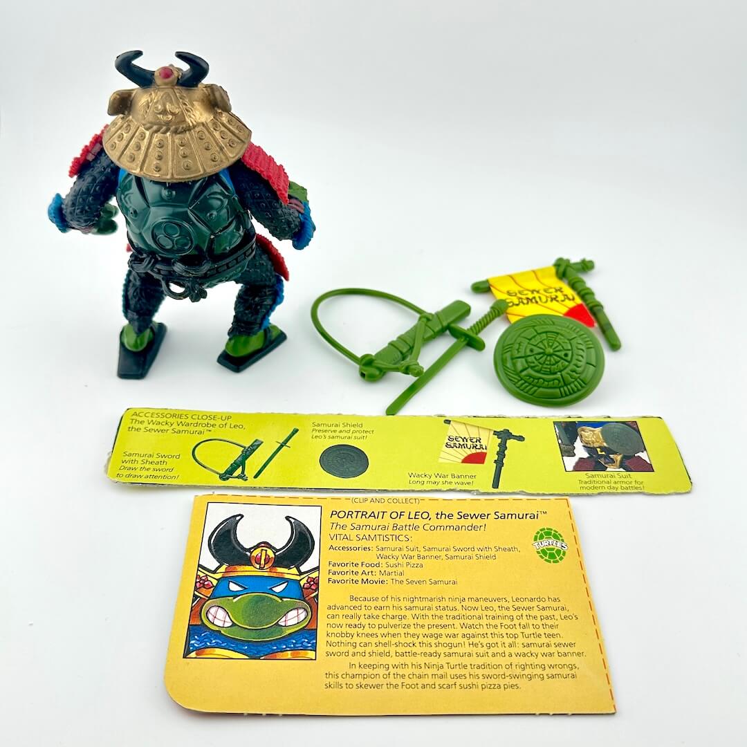 TMNT action figure with card back and accessories against white background.