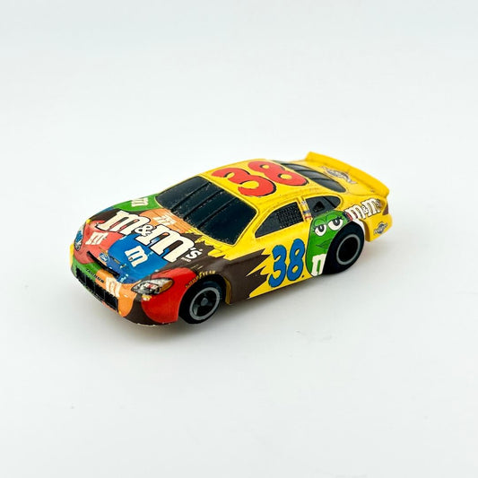 Colorful toy race car with M&M's branding on a white background