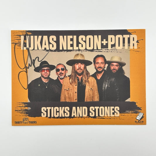 Orange card with photo of five men in leather jackets, beige text at top and bottom: Lukas Nelson+POTR, Sticks and Stones.