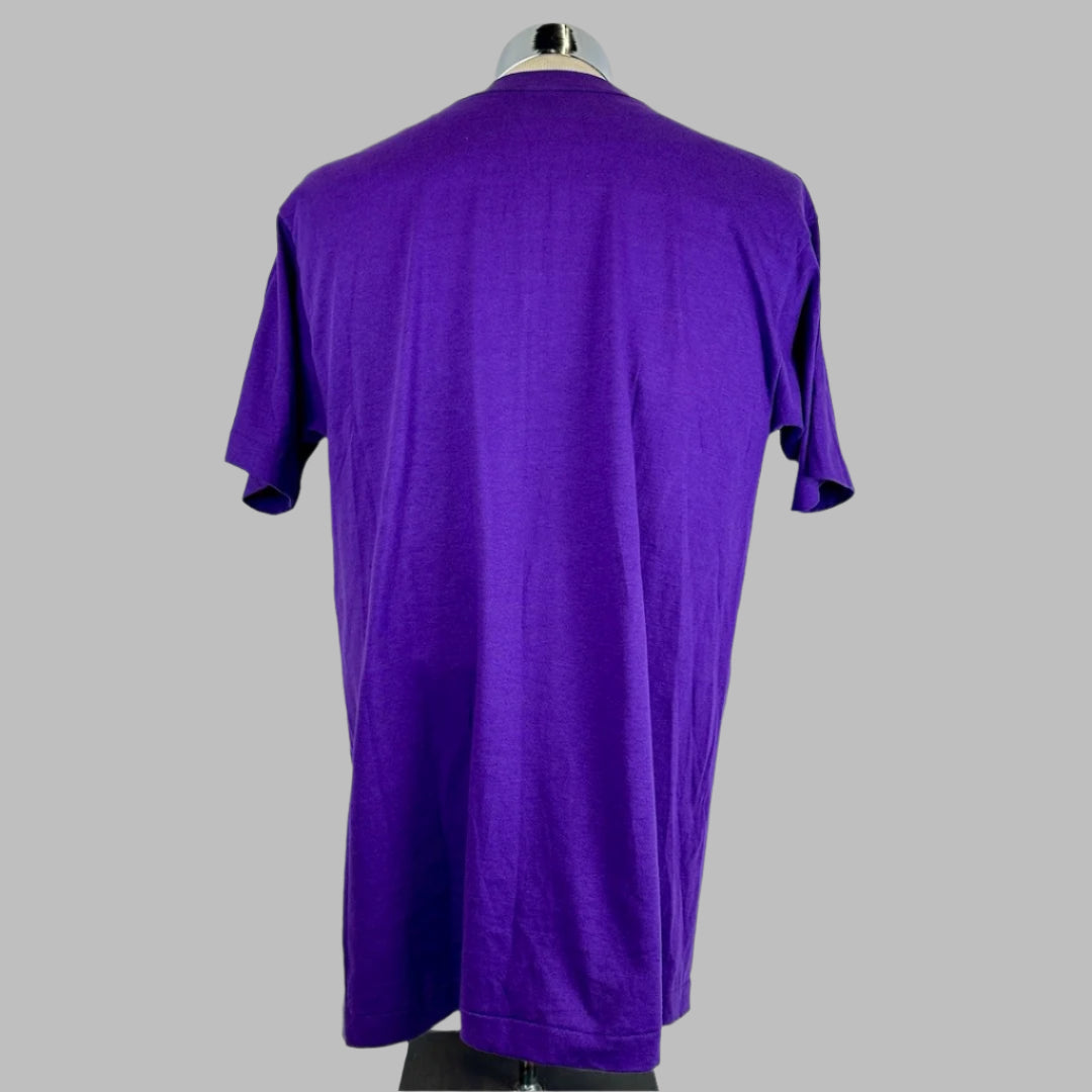 Back of purple short sleeved t-shirt showing no design, damage or stains to shirt.