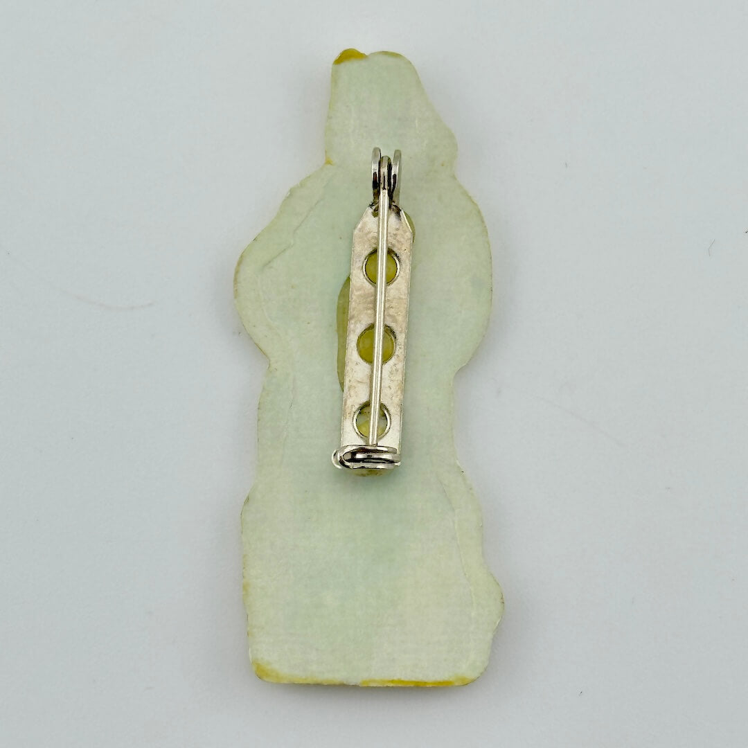 Backside of pin against white background.