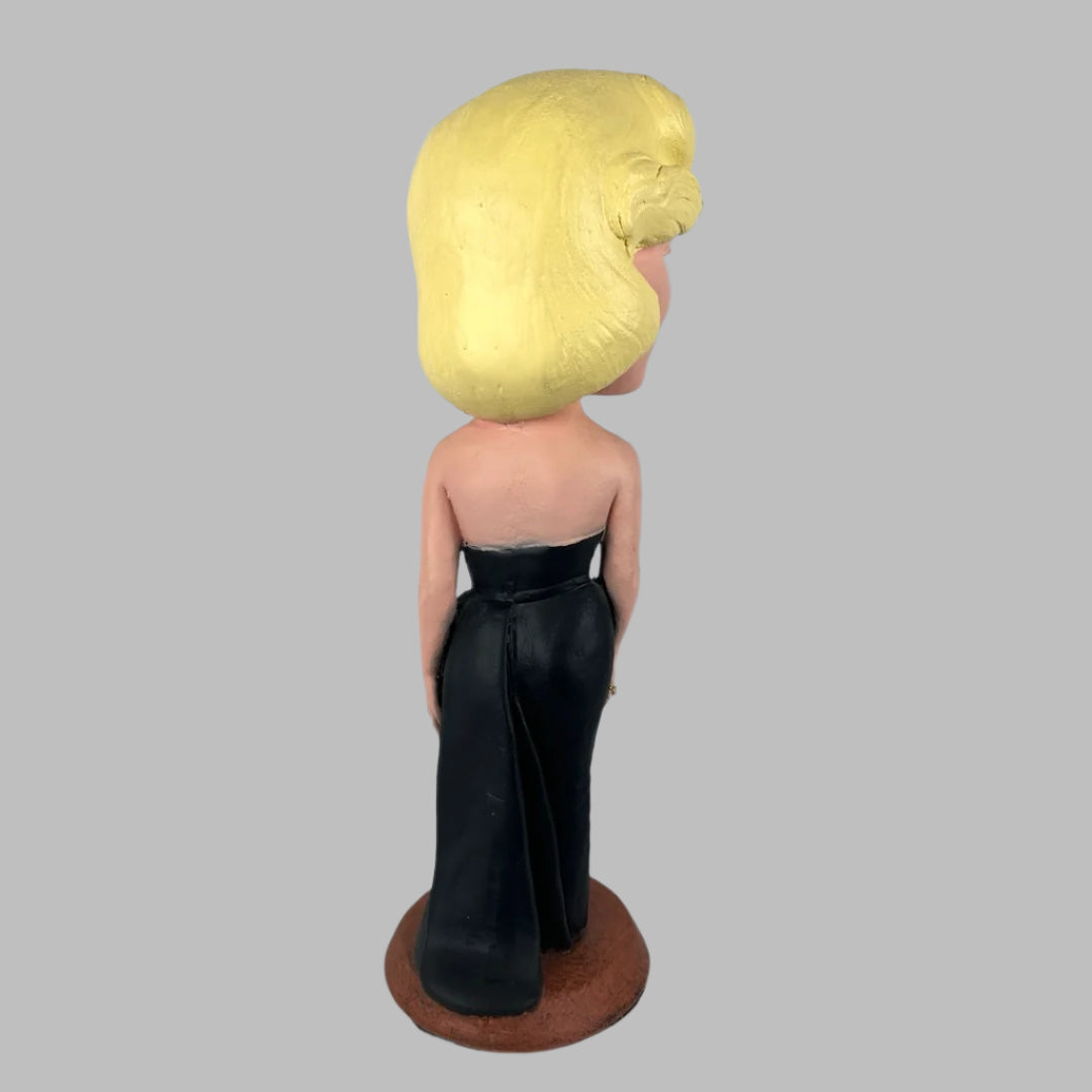 Chalkware figure of Marilyn Monroe in sleeveless long black dress, with red lipstick & blue eyeshadow. Back.