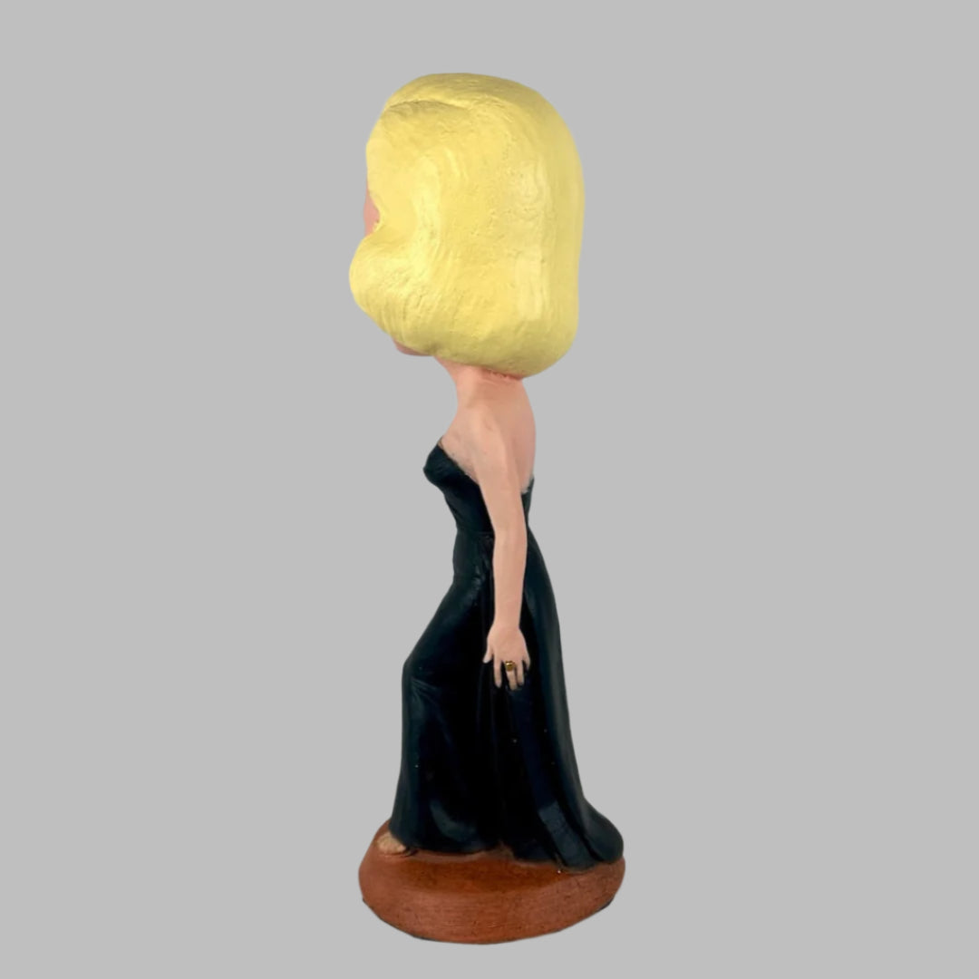 Chalkware figure of Marilyn Monroe in sleeveless long black dress, with red lipstick & blue eyeshadow. Left.