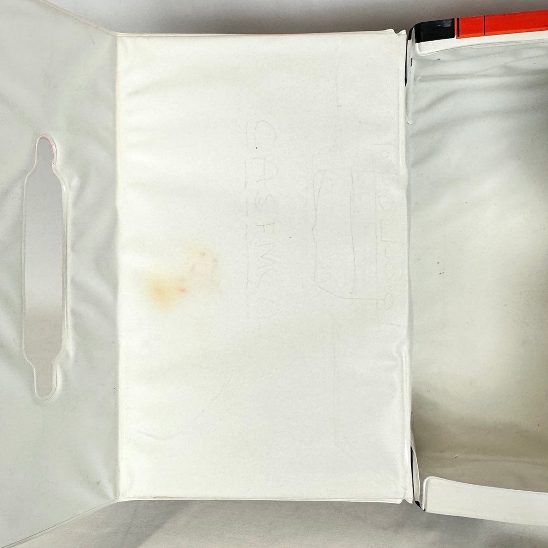 Image of interior of lid to show light pencil remnants and dirt stain by handle.