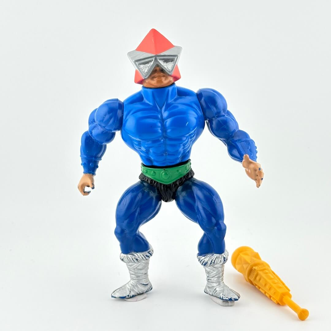 Blue muscular figure front with silver boots, silver glasses and an orange hat. Wearing green belt.