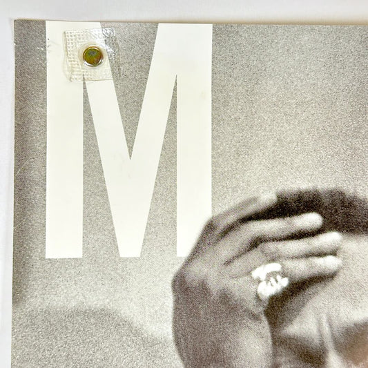 Top left corner of poster with pin holes.