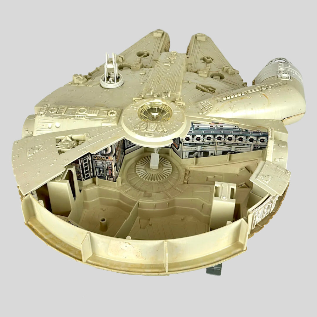 Millennium Falcon toy against light gray background.
