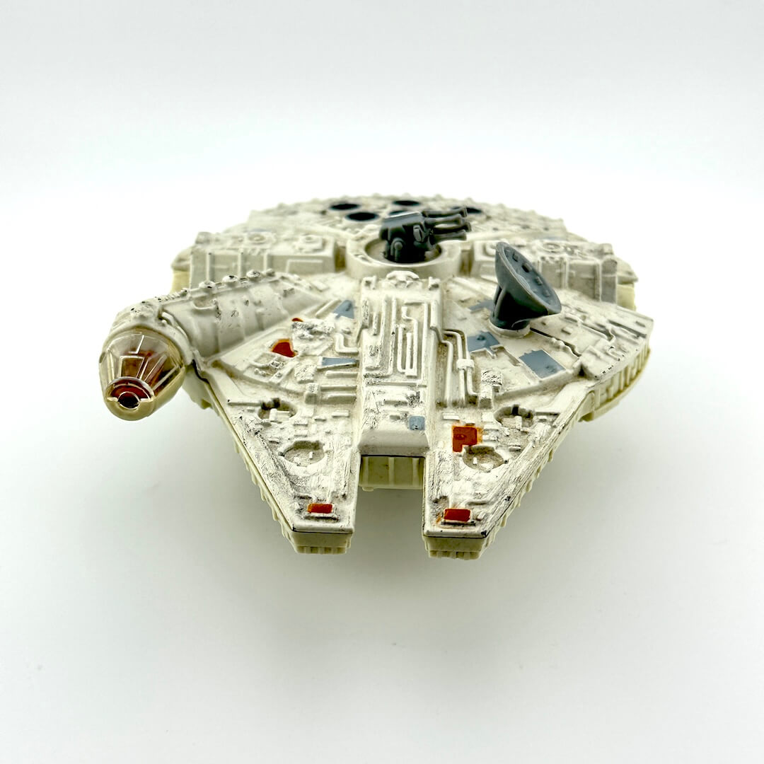 Diecast model of a spaceship of the Millennium Falcon on a white background