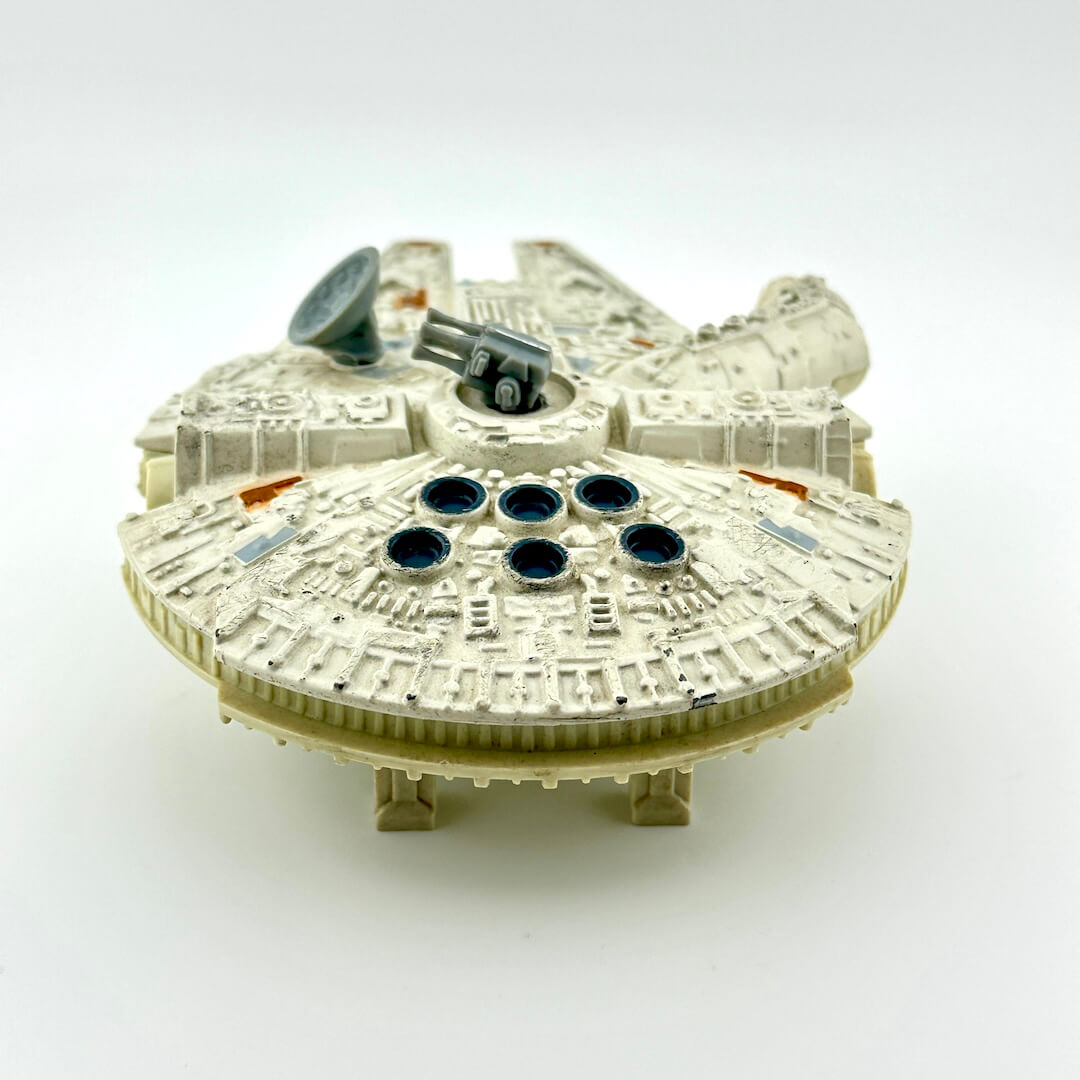 Diecast model of a spaceship of the Millennium Falcon on a white background