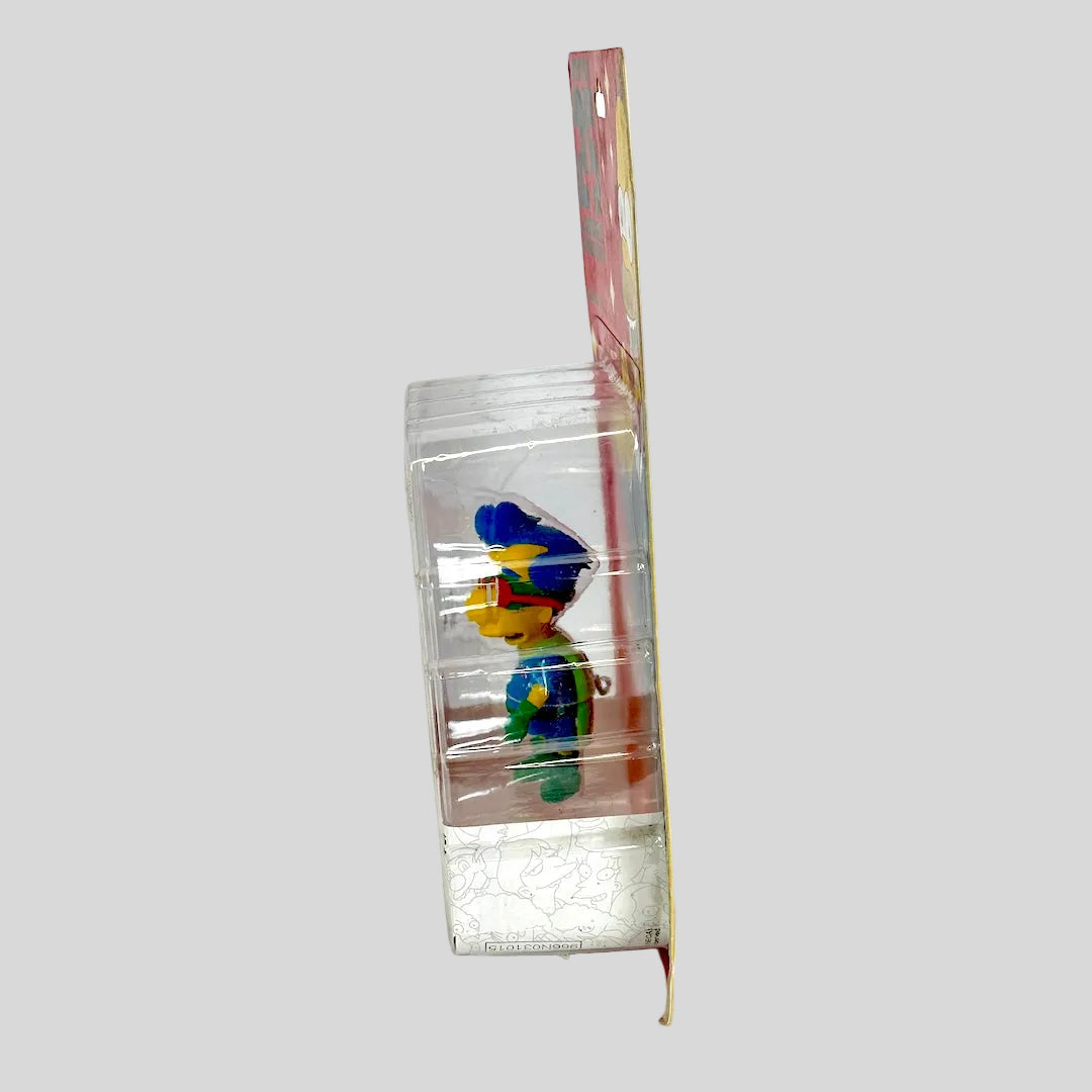 Colorful toy figure in a clear plastic packaging on a white background