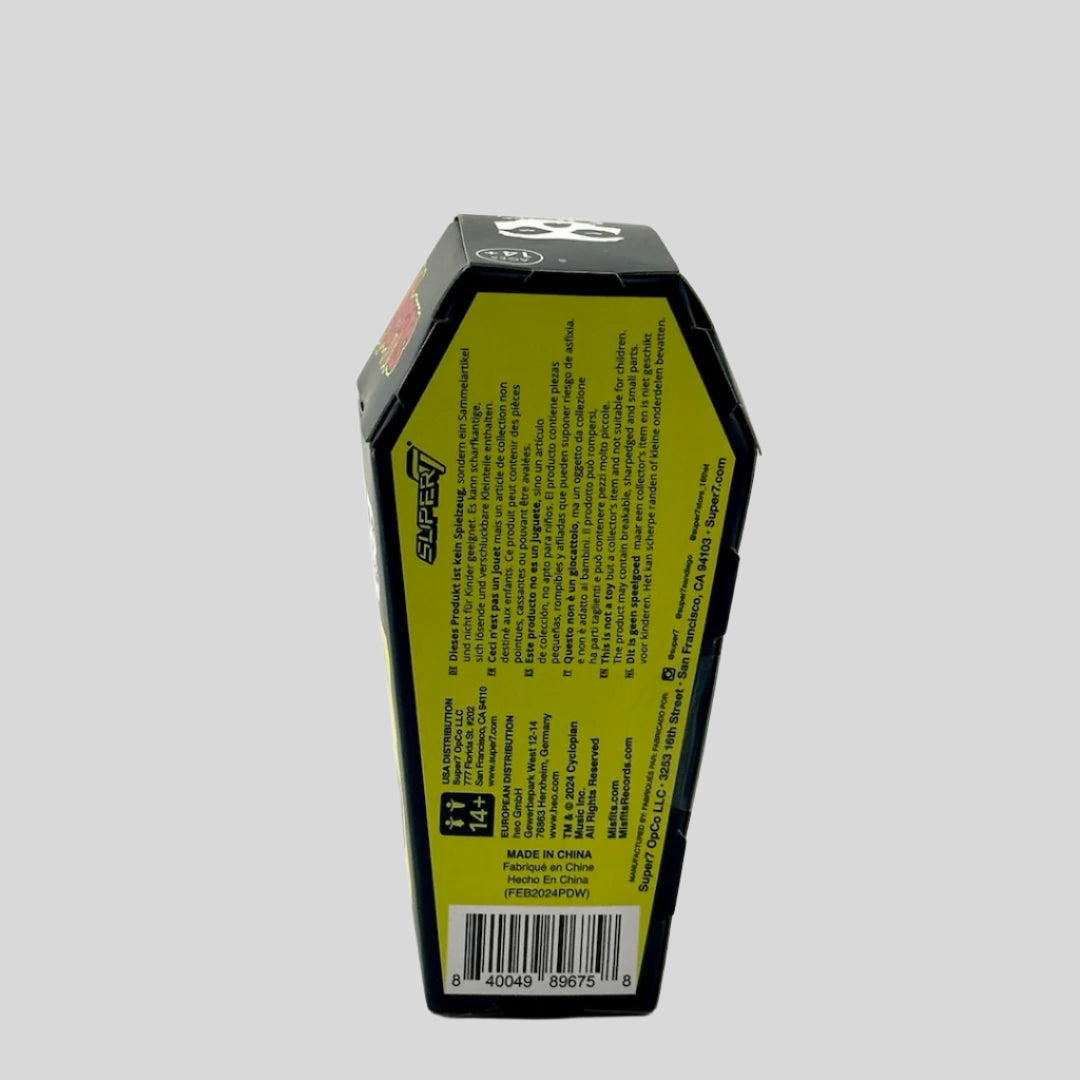 Backside of coffin shaped box to show product and maker information in black text on yellow background.